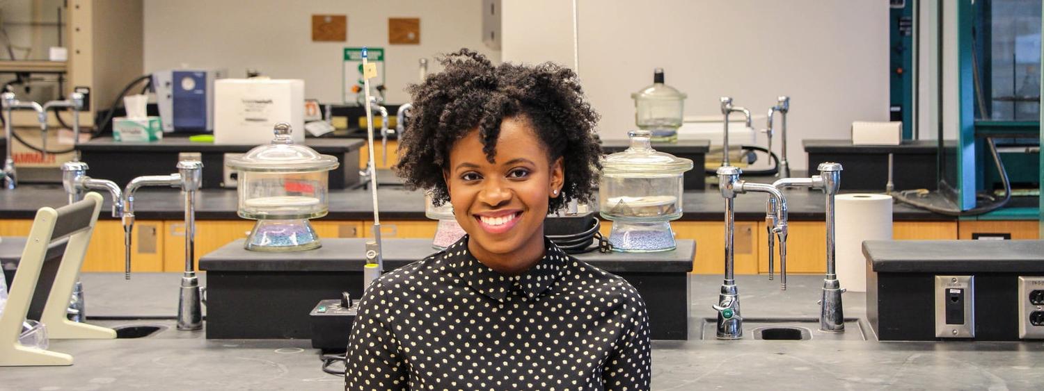 Photo of Chatham University alumane, Christina Austin, smiling in a laboratory.